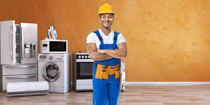 Appliance service specialist standing beside household appliances